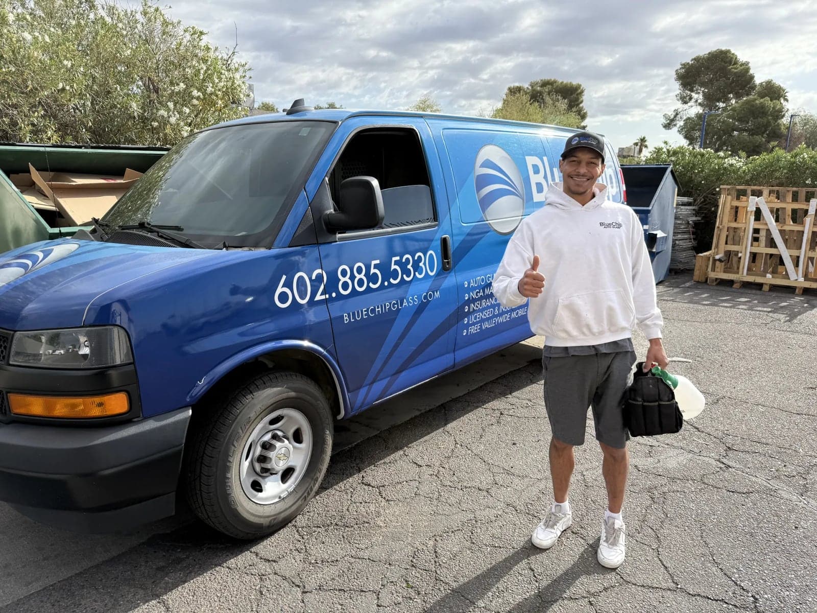 Blue Chip technician next to a Blue Chip Auto Glass van