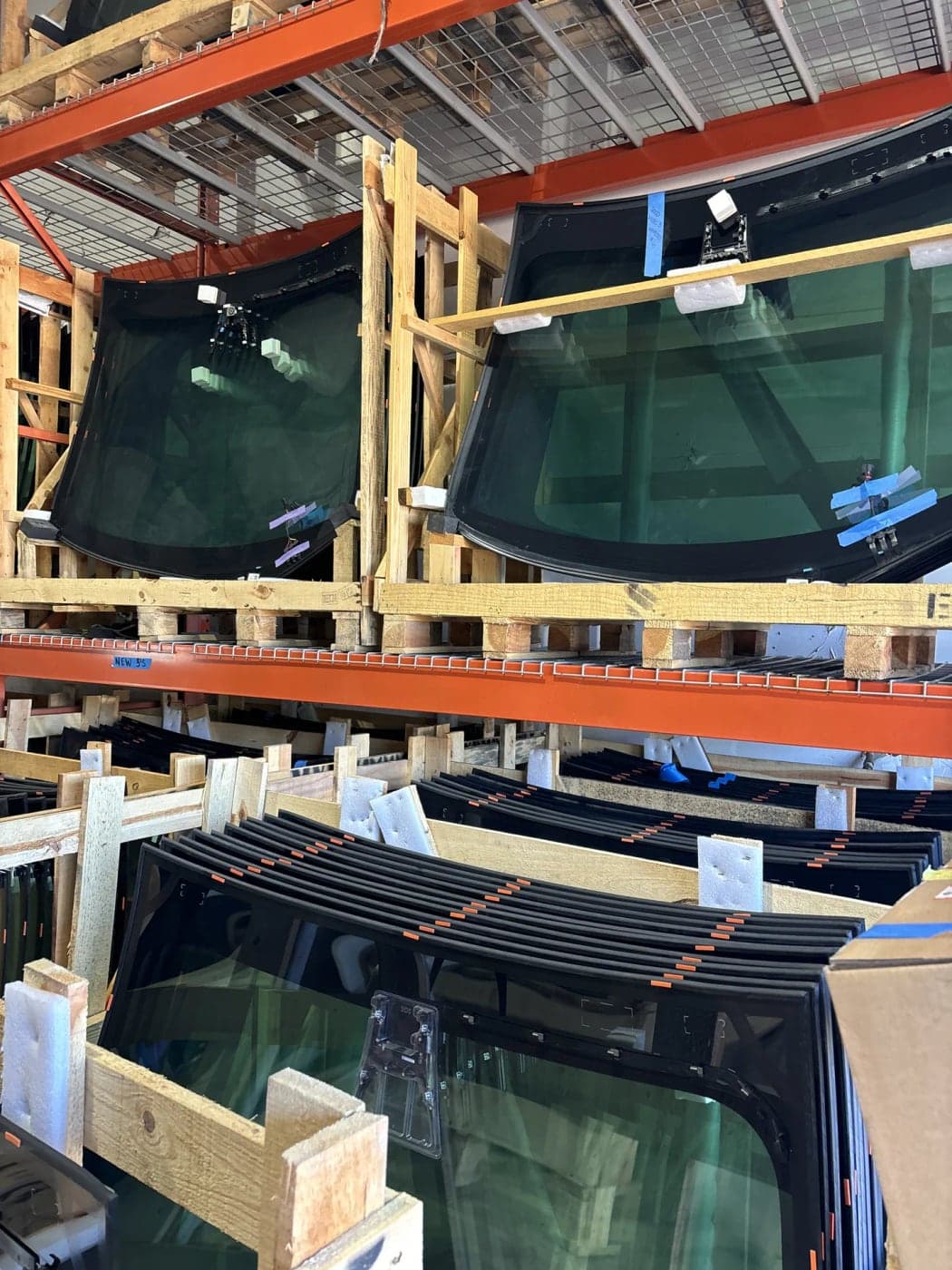 Crated windshields stacked on warehouse racks