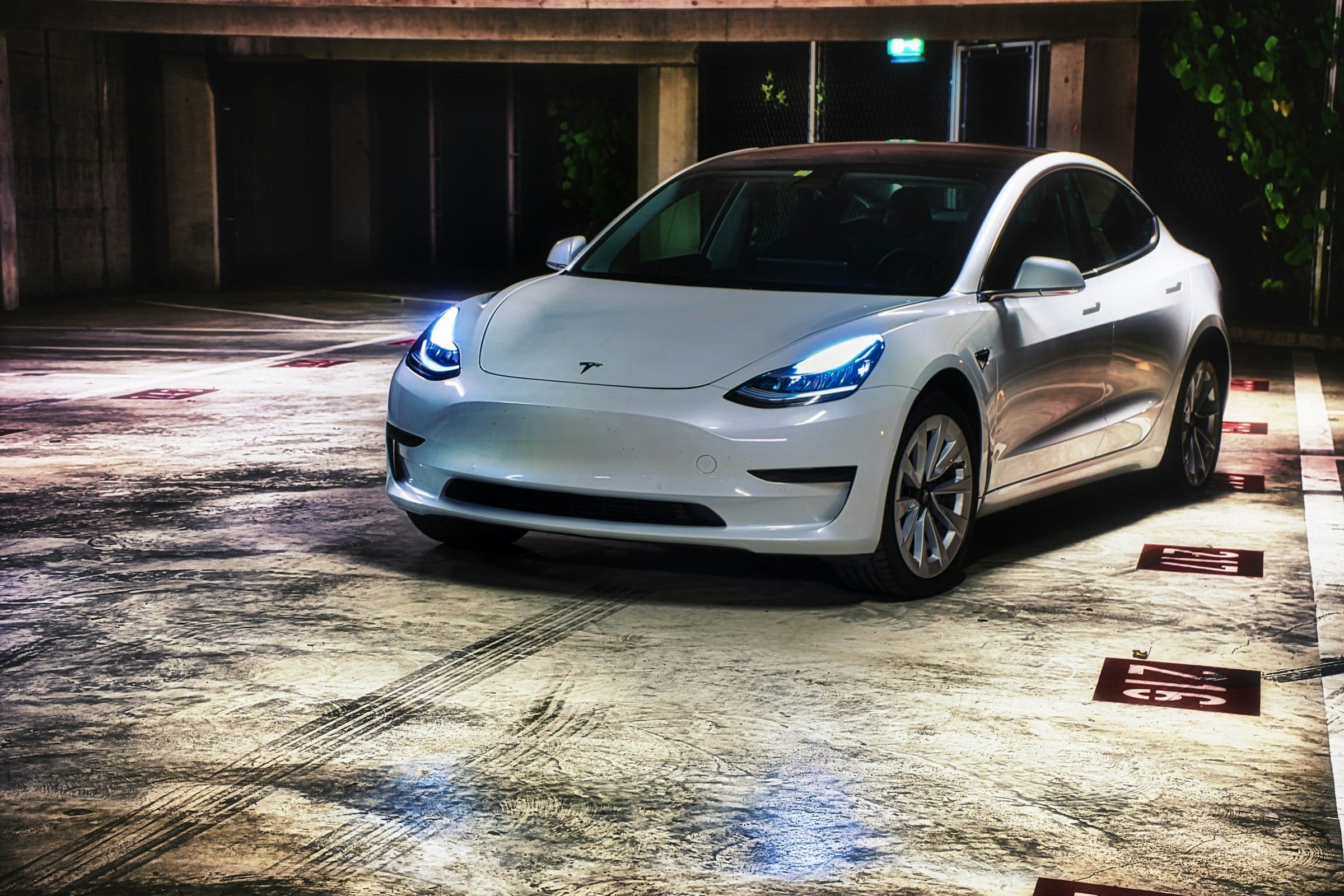 White Tesla Model 3 parked in a garage